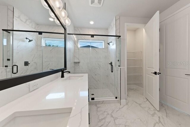 bathroom with vanity and a shower with shower door