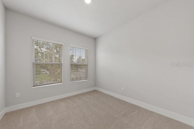 empty room featuring light colored carpet