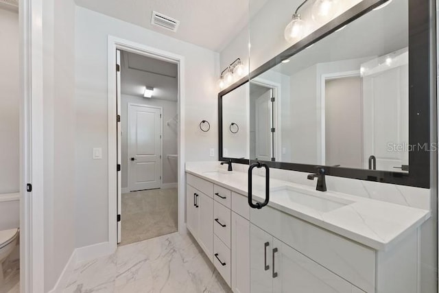 bathroom with vanity and toilet