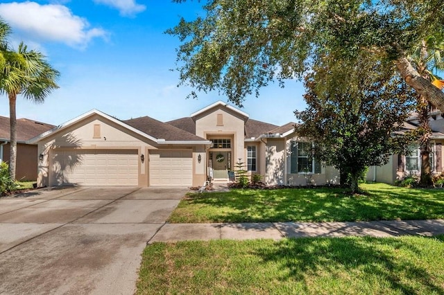 view of front of property featuring a garage and a front lawn