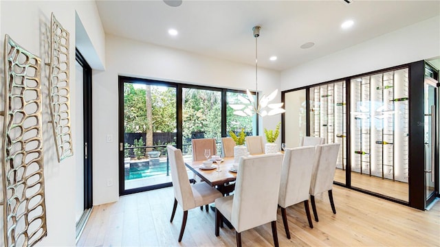 dining room featuring an inviting chandelier and light wood-type flooring