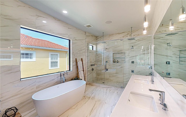 bathroom featuring vanity, tile walls, and independent shower and bath