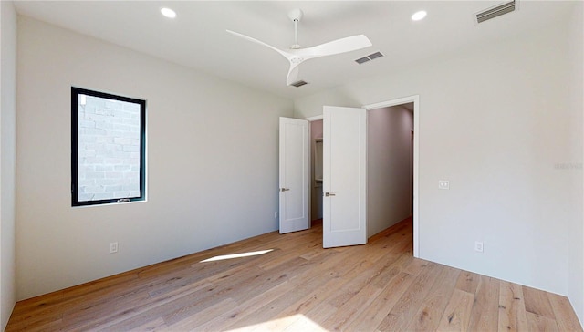 unfurnished bedroom with ceiling fan and light hardwood / wood-style floors