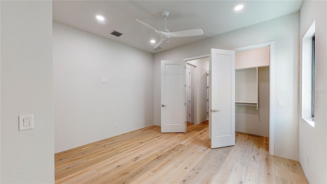 unfurnished bedroom with ceiling fan, light hardwood / wood-style floors, vaulted ceiling, and a closet