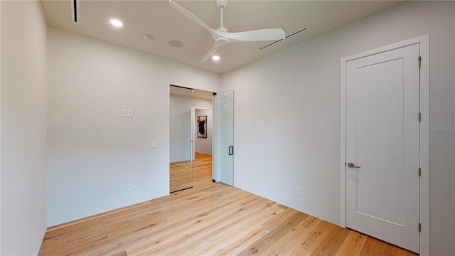 unfurnished bedroom featuring light wood-type flooring and ceiling fan