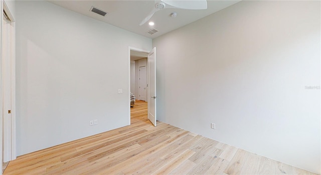 empty room with ceiling fan and light wood-type flooring