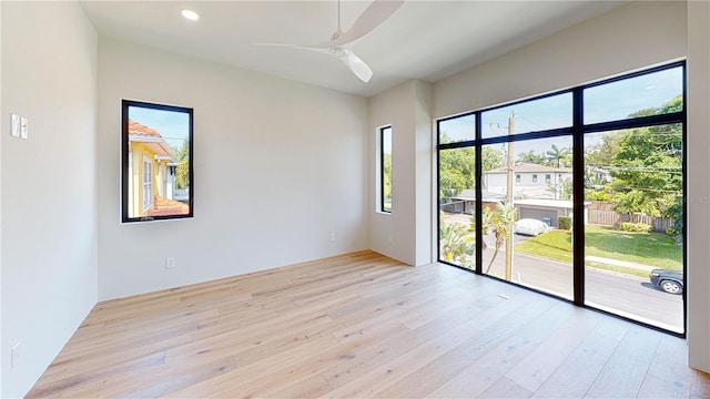 unfurnished room with ceiling fan and light hardwood / wood-style floors