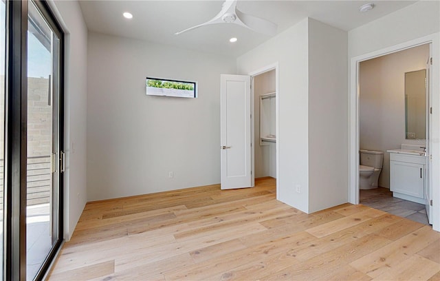 unfurnished bedroom with ceiling fan, light hardwood / wood-style flooring, and ensuite bathroom