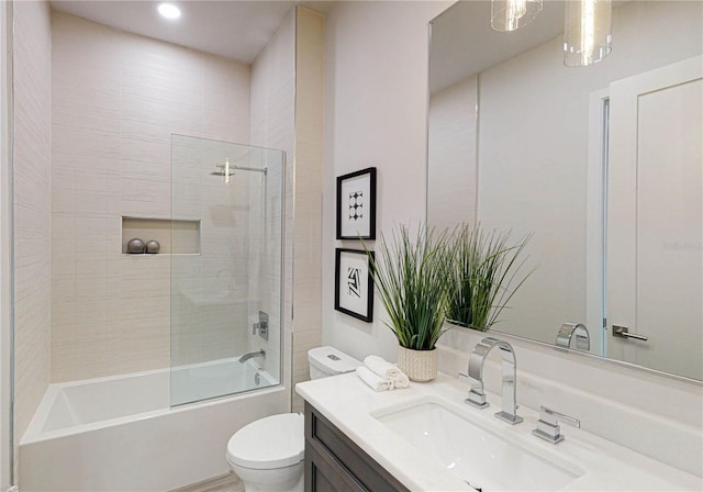 full bathroom with vanity, enclosed tub / shower combo, and toilet