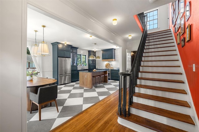 interior space with crown molding, hardwood / wood-style flooring, and a notable chandelier