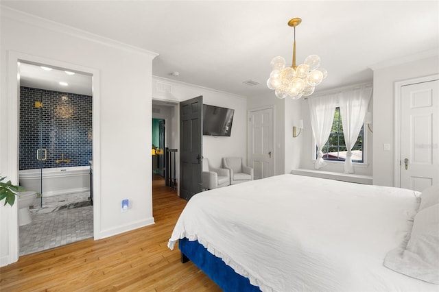 bedroom featuring hardwood / wood-style floors, a chandelier, and ornamental molding