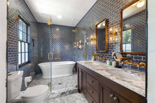 bathroom featuring a bathing tub, plenty of natural light, tile walls, and toilet