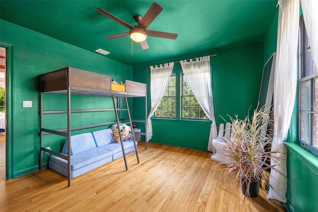 bedroom with light wood-type flooring and ceiling fan