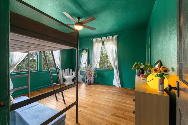 bedroom featuring a textured ceiling and hardwood / wood-style flooring