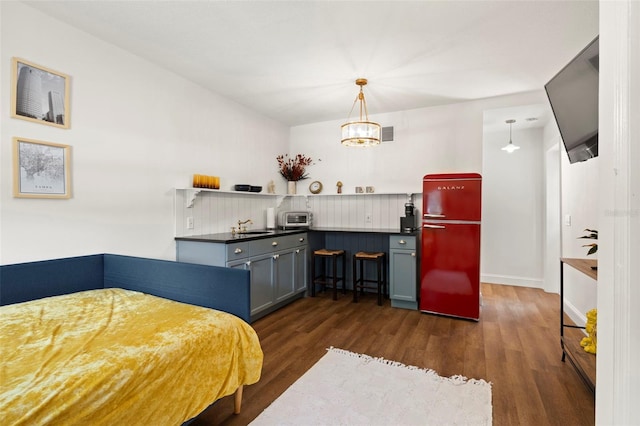 interior space with fridge, dark hardwood / wood-style floors, and a notable chandelier