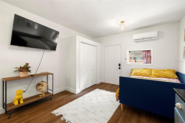 bedroom featuring a wall unit AC, a closet, and dark hardwood / wood-style flooring