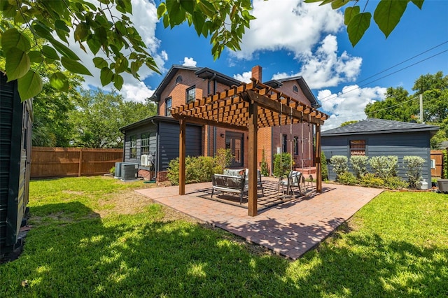 rear view of property featuring a pergola, cooling unit, a patio area, and a lawn