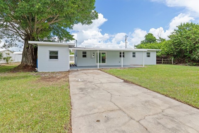 ranch-style home with a front yard and a carport