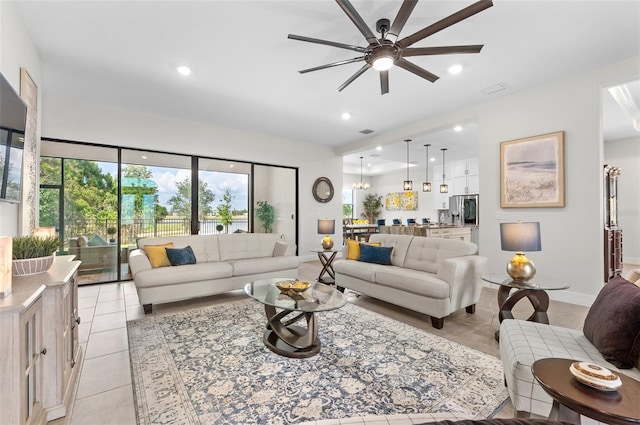 living room with ceiling fan and light tile patterned floors