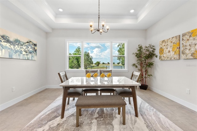 dining room with a notable chandelier, crown molding, and a tray ceiling