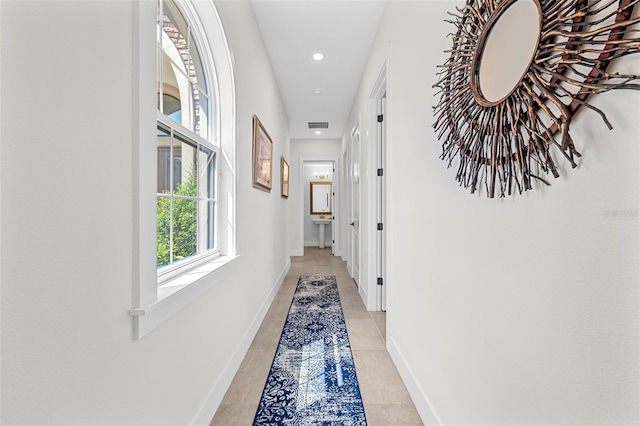 corridor with light tile patterned flooring