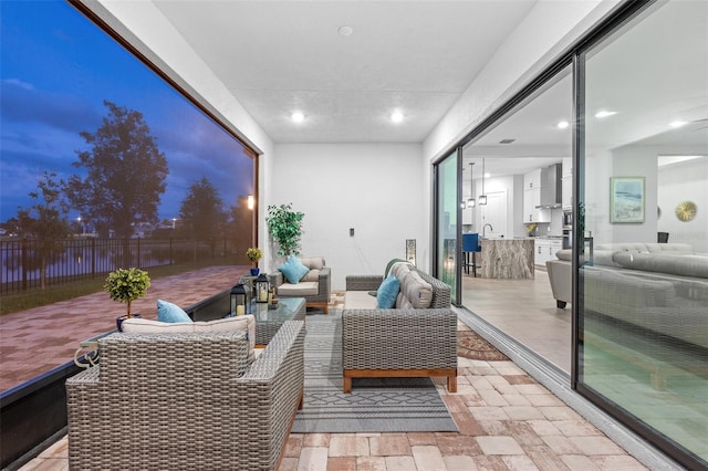 interior space with outdoor lounge area and sink