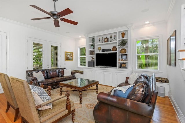 living room featuring plenty of natural light, ceiling fan, ornamental molding, and french doors