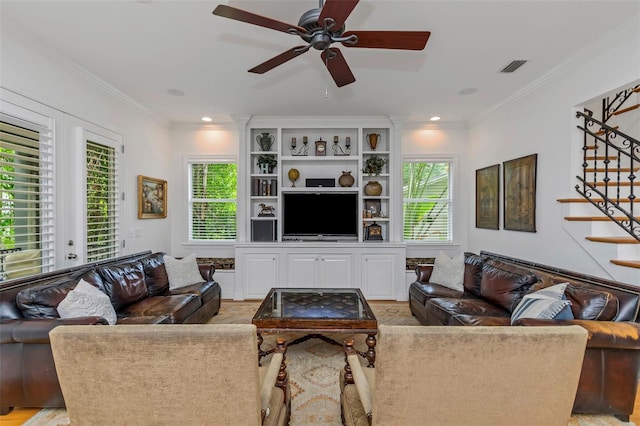 living room featuring ceiling fan, light hardwood / wood-style floors, and crown molding