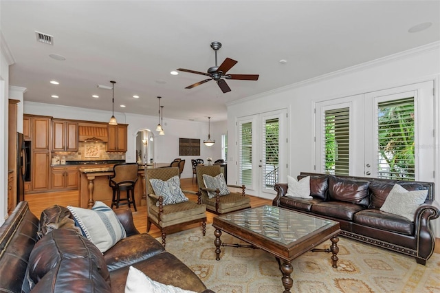 living room with plenty of natural light, ceiling fan, and french doors