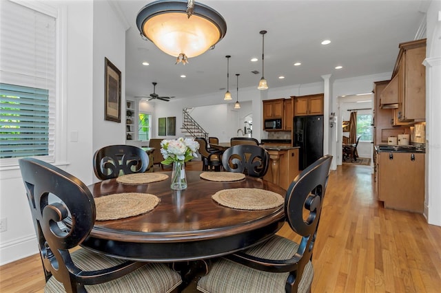 dining space with light hardwood / wood-style floors, ceiling fan, and ornamental molding