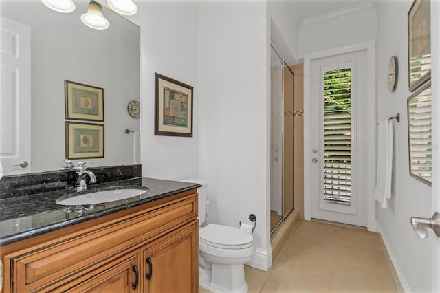 bathroom featuring ornamental molding, vanity, tile patterned flooring, toilet, and a shower with shower door