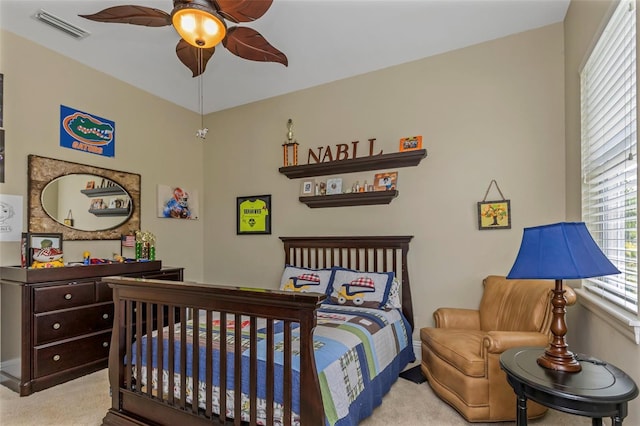 bedroom featuring ceiling fan and light carpet