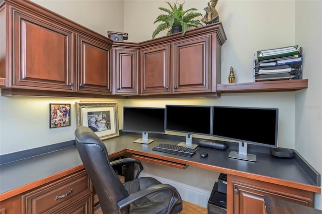 office space with hardwood / wood-style flooring and built in desk