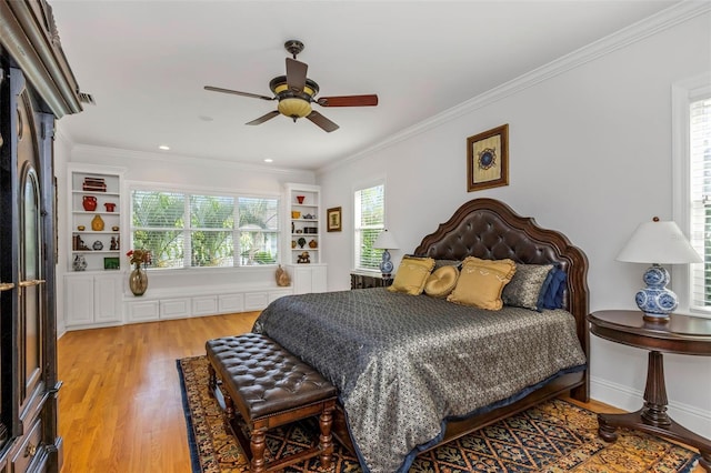 bedroom with ceiling fan, ornamental molding, and light wood-type flooring