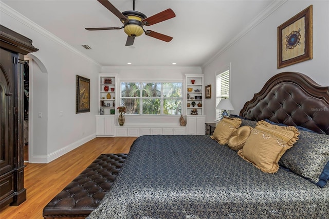 bedroom featuring hardwood / wood-style floors, ceiling fan, and ornamental molding