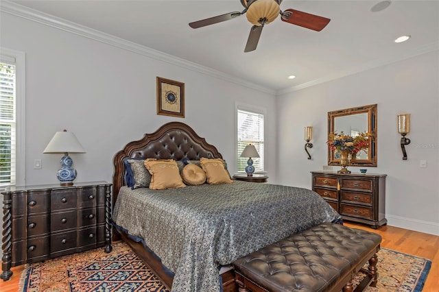 bedroom featuring ceiling fan, ornamental molding, and light wood-type flooring