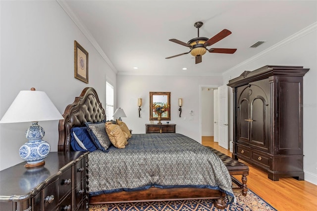 bedroom with ceiling fan, light hardwood / wood-style floors, and ornamental molding