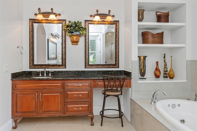 bathroom with tile patterned floors, vanity, and a relaxing tiled tub