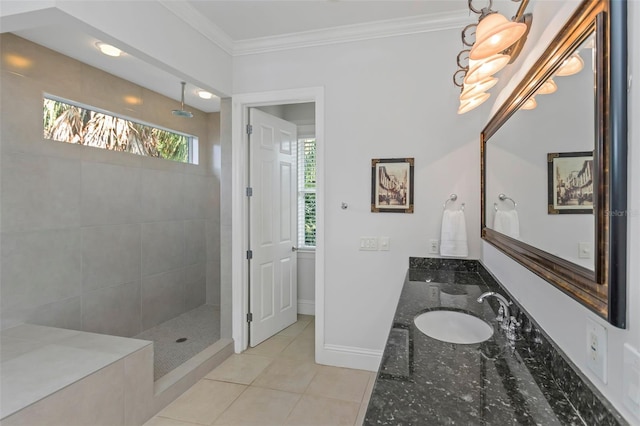 bathroom with a tile shower, vanity, tile patterned floors, and crown molding