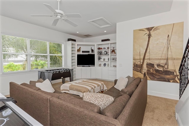 carpeted living room with ceiling fan