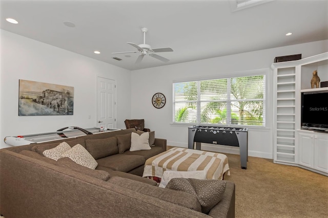 carpeted living room featuring ceiling fan