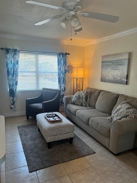 tiled living room featuring a textured ceiling, ornamental molding, and ceiling fan