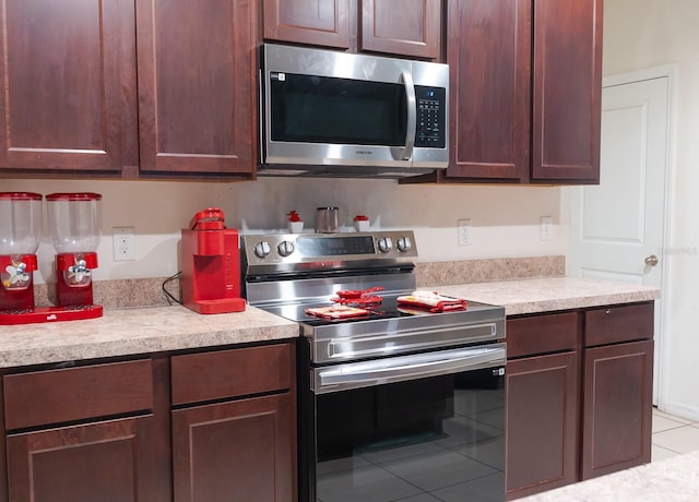 kitchen with stainless steel appliances and light tile patterned floors