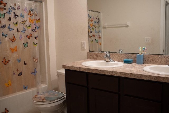 full bathroom featuring shower / bath combination with curtain, vanity, and toilet