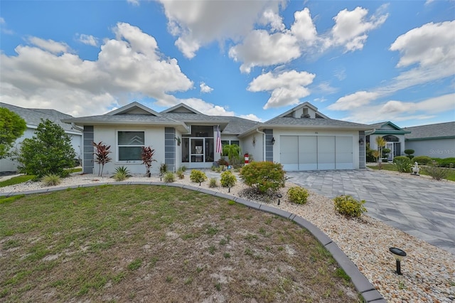 ranch-style house featuring a garage and a front lawn