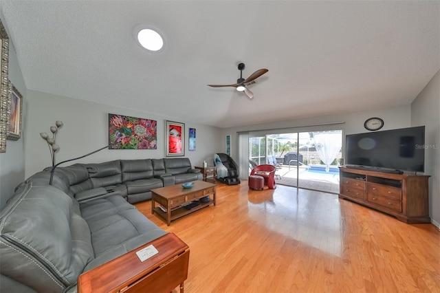 living room with ceiling fan, hardwood / wood-style floors, and lofted ceiling