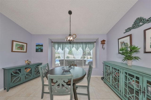 dining room featuring a textured ceiling, light tile patterned flooring, a chandelier, and vaulted ceiling