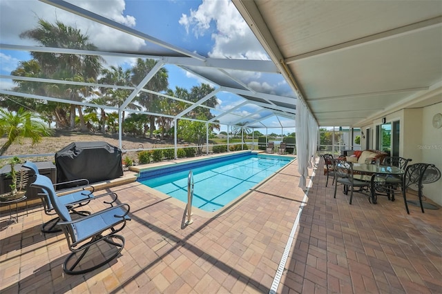 view of swimming pool featuring glass enclosure, a patio area, and a grill