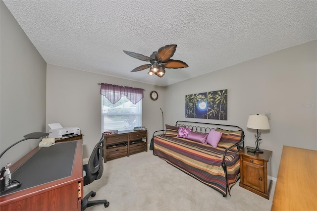 carpeted office featuring ceiling fan and a textured ceiling