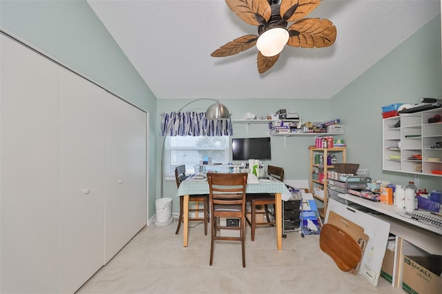 interior space featuring ceiling fan, lofted ceiling, a textured ceiling, and a closet